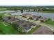 Scenic aerial view of homes nestled around a tranquil lake and lush greenery at 7744 Castleisland Dr, Sarasota, FL 34240