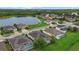 Overhead shot of homes surrounding a scenic lake, showcasing community layout and landscaping at 7744 Castleisland Dr, Sarasota, FL 34240
