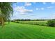 Spacious backyard with lush green grass and open views at 7744 Castleisland Dr, Sarasota, FL 34240