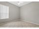 Neutral-toned bedroom with tile floors, natural light and ceiling fan at 7744 Castleisland Dr, Sarasota, FL 34240