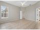 Bright, neutral bedroom featuring ceiling fan, tile floors, and ensuite bathroom at 7744 Castleisland Dr, Sarasota, FL 34240