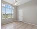 Neutral-toned bedroom filled with natural light and featuring tile flooring at 7744 Castleisland Dr, Sarasota, FL 34240
