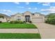 Charming single-Gathering home with lush lawn, mature landscaping, and attached garage at 7744 Castleisland Dr, Sarasota, FL 34240