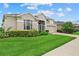Well-maintained single-Gathering home with a manicured lawn and an attached garage at 7744 Castleisland Dr, Sarasota, FL 34240