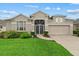 Well-maintained single-Gathering home with a manicured lawn, inviting front entrance at 7744 Castleisland Dr, Sarasota, FL 34240