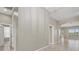 Open hallway with neutral paint, tile flooring, transom window, and entry door at 7744 Castleisland Dr, Sarasota, FL 34240