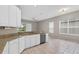 Well-lit kitchen with white cabinets, granite countertops, and stainless steel appliances at 7744 Castleisland Dr, Sarasota, FL 34240