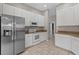 Updated kitchen featuring stainless steel appliances, white cabinets, and granite counters at 7744 Castleisland Dr, Sarasota, FL 34240