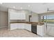 Bright kitchen showcasing white cabinets, granite countertops, and a stainless steel dishwasher at 7744 Castleisland Dr, Sarasota, FL 34240