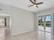 Open living room with sliding glass doors leading to a screened in pool with views at 7744 Castleisland Dr, Sarasota, FL 34240