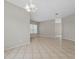 Spacious living room featuring tile floors, neutral paint, white trim, and a chandelier at 7744 Castleisland Dr, Sarasota, FL 34240