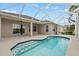 Screened-in pool area with steps leading to a backyard at 7744 Castleisland Dr, Sarasota, FL 34240