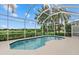 Screened-in pool with lush tropical landscaping creating a private outdoor oasis at 7744 Castleisland Dr, Sarasota, FL 34240