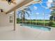 Screened-in pool area with an expansive view of golf course and lush vegetation at 7744 Castleisland Dr, Sarasota, FL 34240