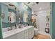 Beautiful renovated bathroom featuring double sinks, unique mirrors, and a walk-in shower at 7915 4Th W Ave # 7915, Bradenton, FL 34209