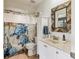 Bathroom featuring a decorative mirror, a shower with a sea-themed curtain, and modern sink and cabinet at 7915 4Th W Ave # 7915, Bradenton, FL 34209