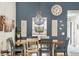 Dining room with view into the kitchen, elegant chandelier, and custom blue wall at 7915 4Th W Ave # 7915, Bradenton, FL 34209