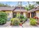 Charming home exterior with lush landscaping, potted plants, and a decorative sun at 7915 4Th W Ave # 7915, Bradenton, FL 34209