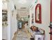 Bright hallway with wood floors, decorated walls, and a glimpse into the living area at 7915 4Th W Ave # 7915, Bradenton, FL 34209