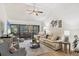 Bright living room with vaulted ceiling, ceiling fan, plush seating, and screened lanai view at 7915 4Th W Ave # 7915, Bradenton, FL 34209