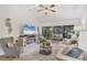 Cozy living room with fireplace, entertainment center, and view of the relaxing screened lanai at 7915 4Th W Ave # 7915, Bradenton, FL 34209