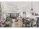 Open living and dining area featuring vaulted ceilings, tile floors, and sliding glass doors to the outside at 7915 4Th W Ave # 7915, Bradenton, FL 34209