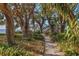 A nature trail surrounded by lush greenery leads to the water, offering a serene path at 7915 4Th W Ave # 7915, Bradenton, FL 34209