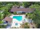 Community pool and spa surrounded by lounge chairs and lush landscaping at 7915 4Th W Ave # 7915, Bradenton, FL 34209