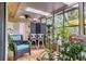 Charming sunroom with natural light, lush plants, and cozy seating with views of the outdoors at 7915 4Th W Ave # 7915, Bradenton, FL 34209
