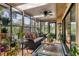 Bright sunroom offering abundant plants, comfortable seating, natural light and tranquil views of the landscape at 7915 4Th W Ave # 7915, Bradenton, FL 34209