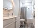 Bathroom with a gray tile floor, white cabinets and a shower and tub combo at 8148 Sternway Rd, Sarasota, FL 34240