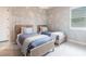 Bright bedroom features two twin beds with blue and white bedding and woven headboards at 8148 Sternway Rd, Sarasota, FL 34240
