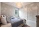 This cozy bedroom features twin beds, a decorative light fixture, and neutral colors that add to the room's design at 8148 Sternway Rd, Sarasota, FL 34240