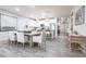 Open-concept dining room next to the kitchen with light-colored walls and floors provides a welcoming place to gather at 8148 Sternway Rd, Sarasota, FL 34240