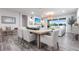 The dining room features an open concept with plenty of natural light and decorative fixtures with a view of the backyard at 8148 Sternway Rd, Sarasota, FL 34240