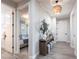 Elegant hallway featuring stylish light fixtures, neutral decor, and wood-look tile flooring at 8148 Sternway Rd, Sarasota, FL 34240