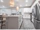 Bright kitchen with stainless steel appliances, white cabinetry, and stylish pendant lighting at 8148 Sternway Rd, Sarasota, FL 34240