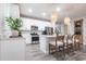 This well-lit kitchen features white cabinetry, stainless steel appliances, a center island, and stylish pendant lighting at 8148 Sternway Rd, Sarasota, FL 34240