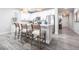 Stylish kitchen featuring a center island with seating, white cabinetry, and modern fixtures at 8148 Sternway Rd, Sarasota, FL 34240