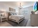 This main bedroom has a decorative chandelier with furniture and neutral colors that complement the design at 8148 Sternway Rd, Sarasota, FL 34240