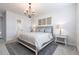 This main bedroom features a decorative chandelier and bedside tables on either side of the bed at 8148 Sternway Rd, Sarasota, FL 34240