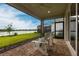Relaxing patio with outdoor seating and a picturesque view of the lake and surrounding homes at 8148 Sternway Rd, Sarasota, FL 34240