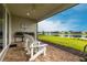 Covered patio with brick pavers, outdoor seating, and a scenic view of the lake at 8148 Sternway Rd, Sarasota, FL 34240
