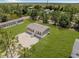 Birds eye view of home with gravel driveway and large manicured lawn at 8426 Sweden Blvd, Punta Gorda, FL 33982