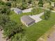 Aerial view of the home with a lush lawn and gravel driveway at 8426 Sweden Blvd, Punta Gorda, FL 33982
