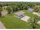 Aerial view of home with gravel driveway and large manicured lawn at 8426 Sweden Blvd, Punta Gorda, FL 33982