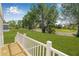 View of the spacious backyard and lush green lawn from the wooden back porch at 8426 Sweden Blvd, Punta Gorda, FL 33982