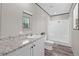 Bathroom featuring a shower-tub combo, granite-look vanity, and wood-look floors at 8426 Sweden Blvd, Punta Gorda, FL 33982