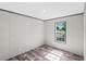 Bedroom with wood-look flooring and window providing natural light at 8426 Sweden Blvd, Punta Gorda, FL 33982