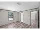 Bedroom with wood-look flooring featuring a window and two entryways at 8426 Sweden Blvd, Punta Gorda, FL 33982